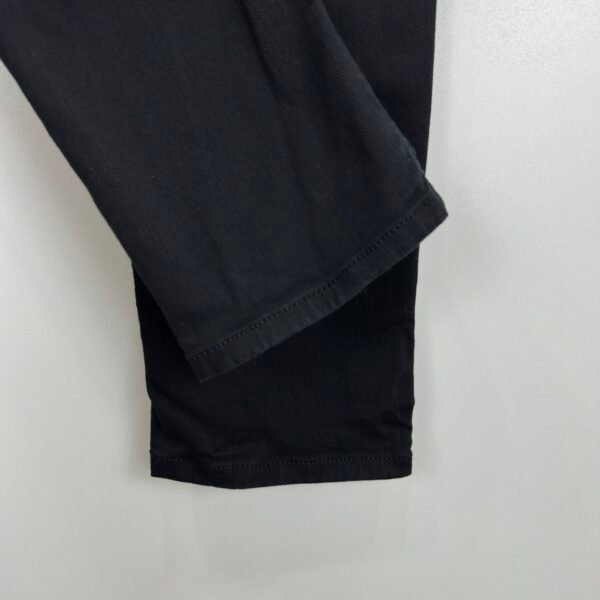 Close-up of the tapered leg hems on Diesel 2005 black jeans